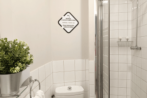 Modern private bathroom detail of the 12-bed shared room, featuring a clean and functional design
