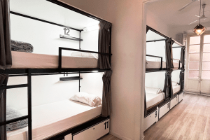 Bunk beds in a 12-bed shared room with shared bathroom, ideal for backpacker groups