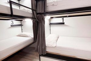 Wooden bunk beds in a 6-bed shared room with private bathroom