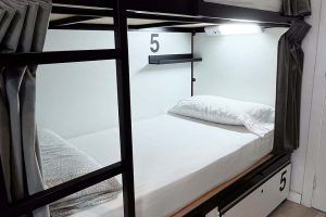 Sleeping area and bunk beds in a 6-bed room with shared bathroom