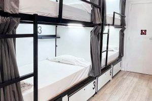 Bunk beds in a shared room with shared bathroom, ideal for groups of travelers