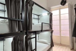Interior view of the 8-bed shared room with shared bathroom at Way Hostel Madrid