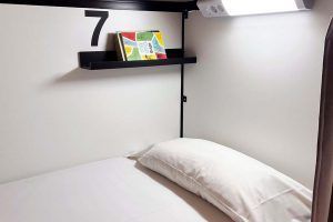 8-bed shared room with shared bathroom and wooden bunk beds