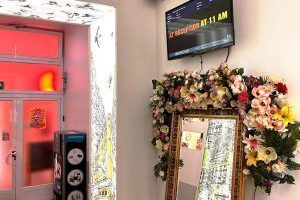 Colorful entrance with information screen and floral decorations