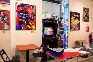 Common area at Way Hostel Madrid with colorful art and a game area