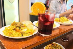Dishes, including paella and refreshing drinks, served as dinner at Way Hostel